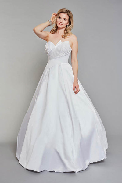 Bride wearing strapless wedding dress with beautiful pleated detail on both the front and back of the gown.