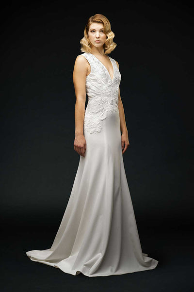 Silk crepe, asymmetrical embroidered bodice with fitted trumpet skirt and puddle train wedding gown