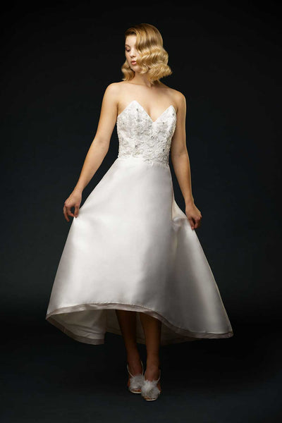 Bride wearing Silk mikado strapless sweetheart wedding gown with all over beaded floral motif.