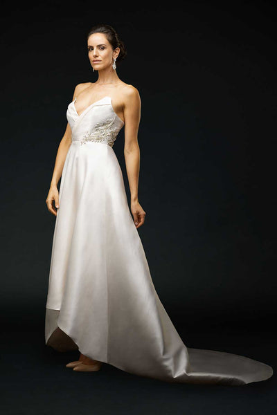 Bride wearing strapless wedding gown with contrast neckline and striking Swarovski crystal beading at waist.