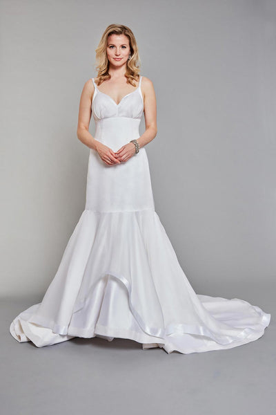 Bride wearing fitted, low-cut, empire-waisted gown with delicate straps and a soft gathered bodice overlay. silk wedding dress